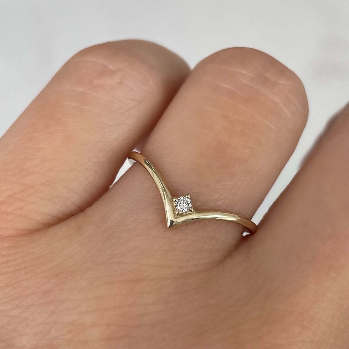 V shaped ring with single diamond drop in the centre
